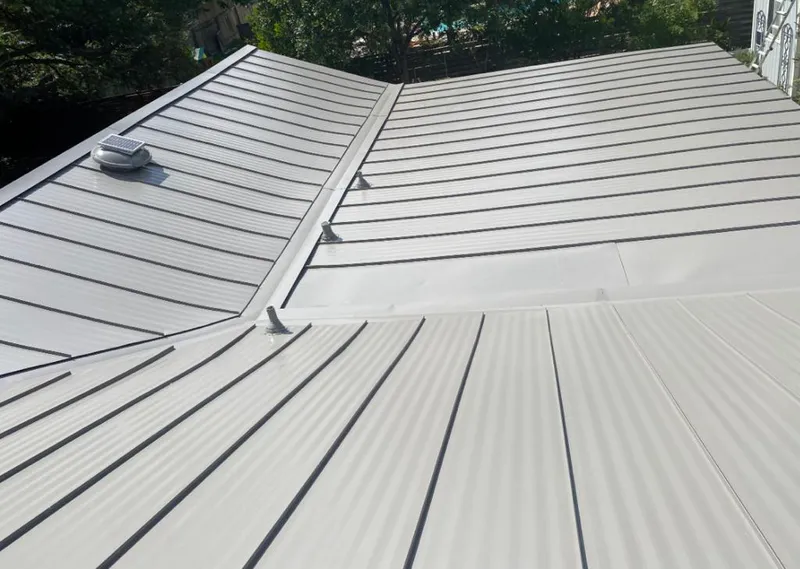 Solar attic fan installed on a metal roof for Roof Ventilation in Micco
